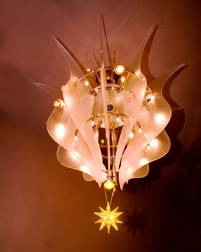 a fantastic looking lighting sculpture that looks like a tear drop with a fancy looking star hanging from it