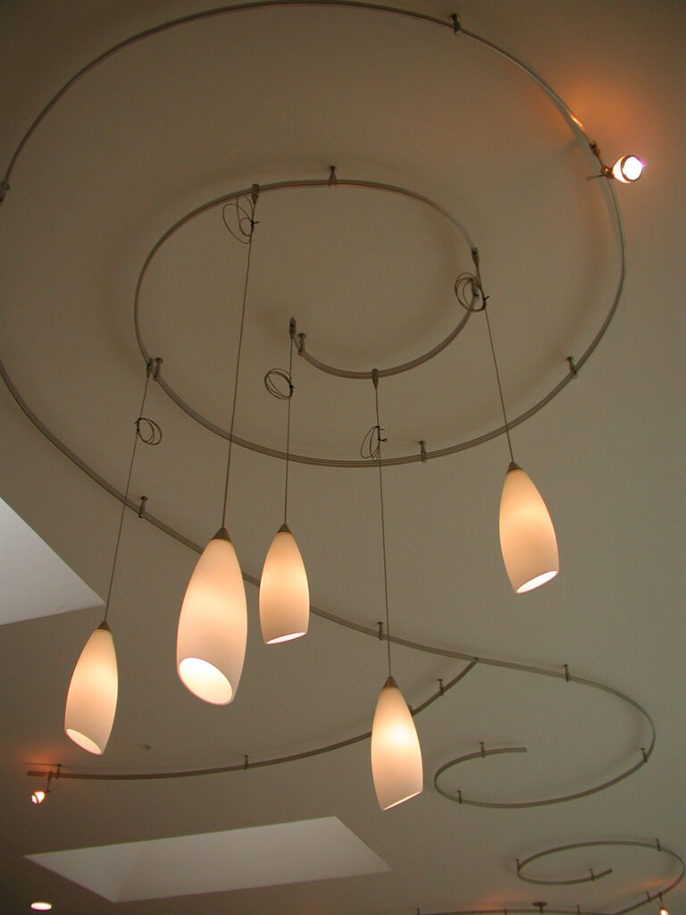 an image of an interior lighting installation of curly lights on a ceiling