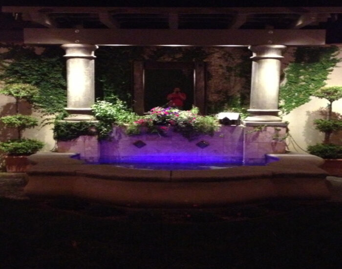 an image of a fountain with some blue LED lighting coming from inside of it