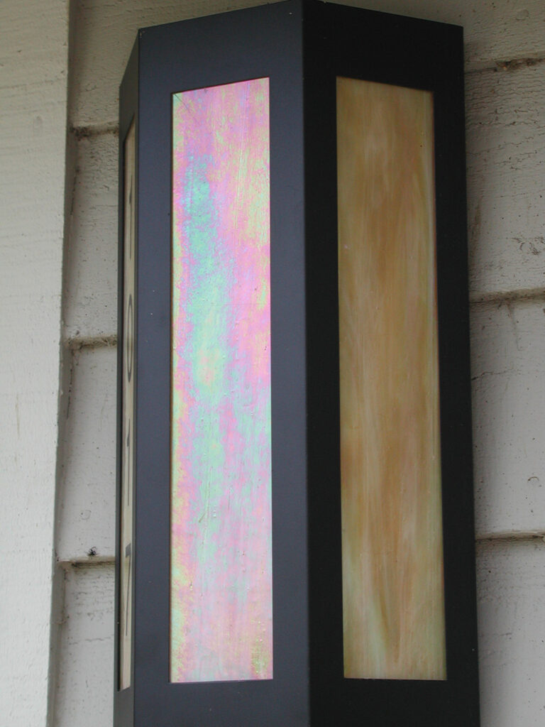 an image of a hexagonal shaped illuminated wall sconce mounted on a wall