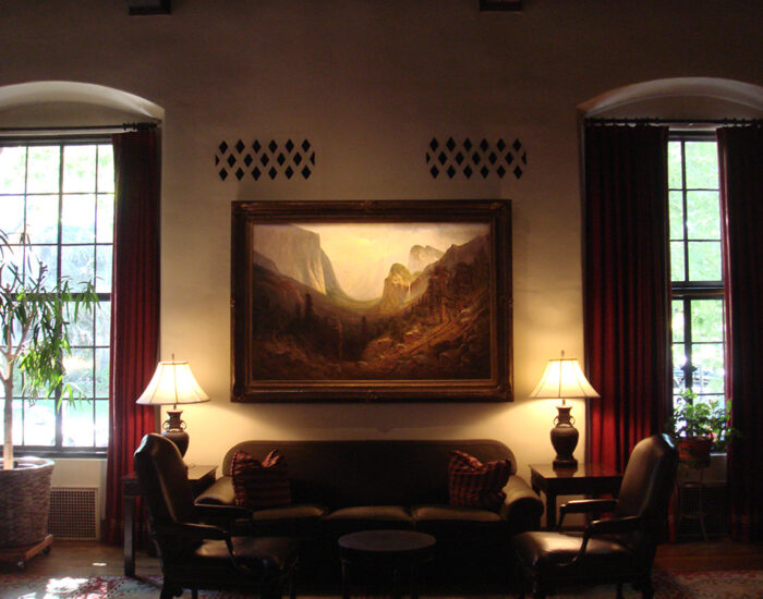 an image of a seating area in the Sutter Club Library Room with lamps illuminating the scene
